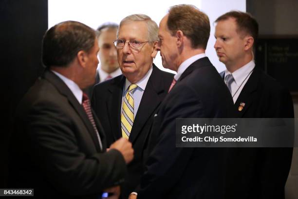 Senate Majority Leader Mitch McConnell talks with Sen. Mike Rounds and Sen. Pat Toomey after leaving a classified briefing by members of the Trump...