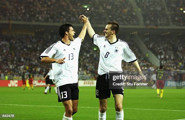 Michael Ballack and Dietmar Hamann of Germany celebrate during the FIFA World Cup Finals 2002 Group E match between Germany and Cameroon played at...