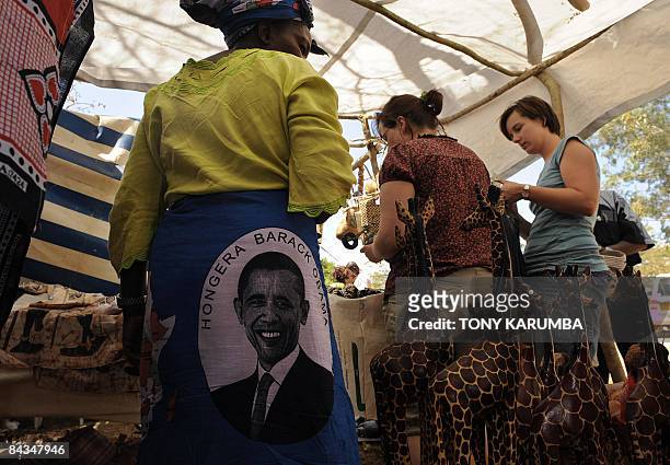 Photo made January 18, 2009 shows tourists shopping in a stall selling 'Obama' merchandise at Nyang'oma village, Kogelo, during festivities to...