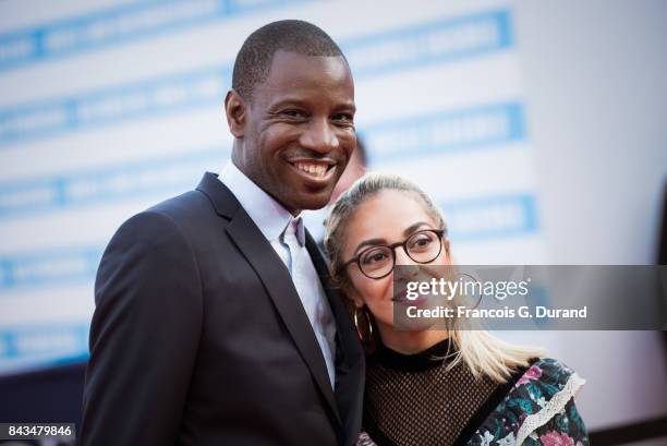 Abd Al Malik and wife Wallen pose on the red carpet before the screening of the movie "The Music Of Silence" during the 43rd Deauville American Film...