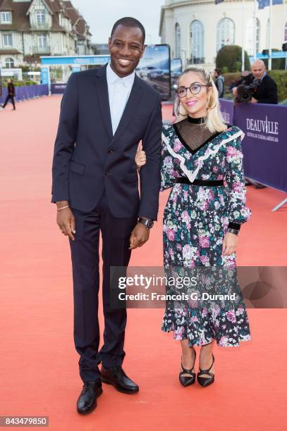 Abd Al Malik and wife Wallen pose on the red carpet before the screening of the movie "The Music Of Silence" during the 43rd Deauville American Film...