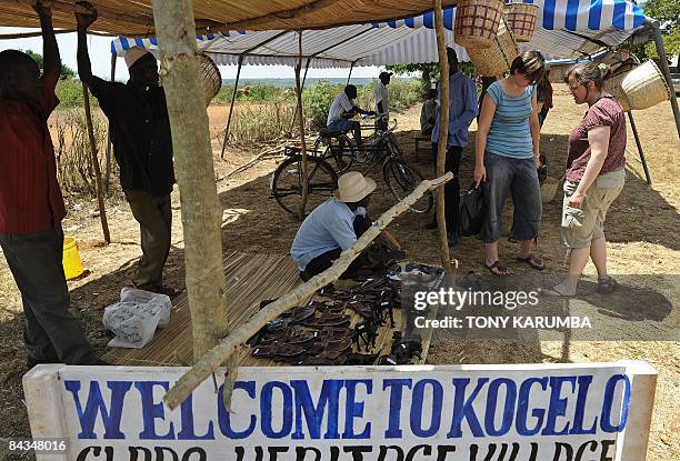 Photo taken January 18, 2009 shows tourists shopping in a stall selling Obama-related merchandise at Nyang'oma village, Kogelo during festivities to...