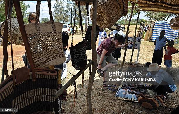 Photo taken January 18, 2009 shows tourists shopping in a stall selling Obama-related merchandise at Nyang'oma village, Kogelo during festivities to...