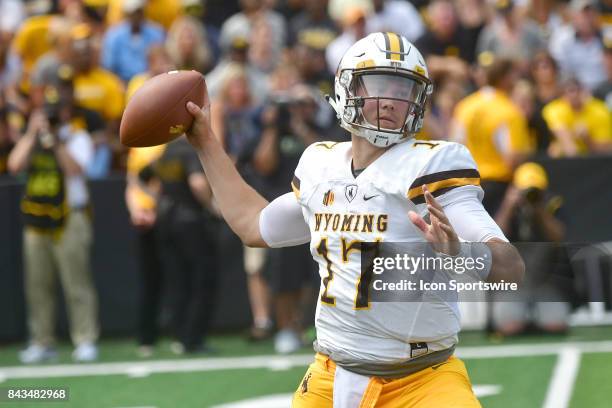 Wyoming Cowboys' quarterback Josh Allen looks to pass during a non-conference college football game between the Wyoming Cowboys and the Iowa...