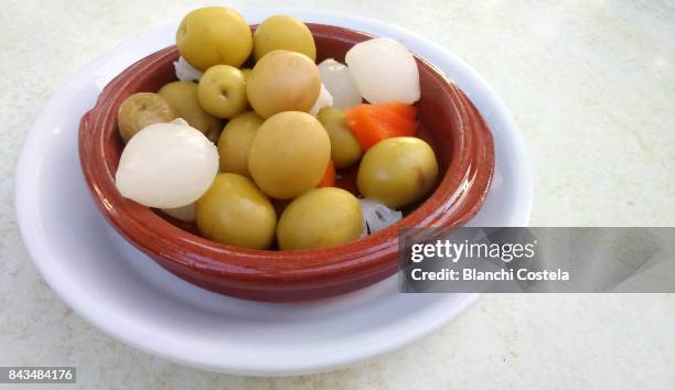 spanish tapa of green olives and onions marinated in olive oil - spanish olive stock pictures, royalty-free photos & images