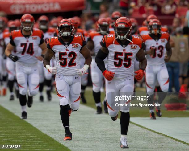 Cincinnati Bengals linebackers Brandon Bell and Vontaze Burfict lead their teammates onto the field prior to the NFL preseason game between the...