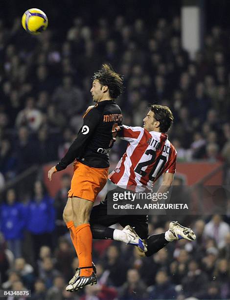 Valencia's Fernando Morientes jumps for a high ball with Athletic de Bilbao's Aitor Ocio during a Spanish League football match at the San Mames...