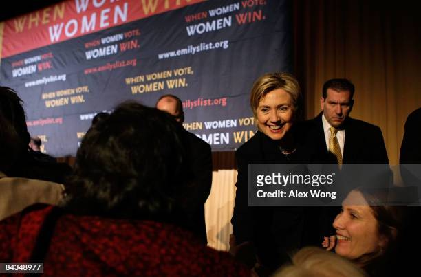 Secretary of State-designate Sen. Hillary Clinton greets people as she attends a luncheon of Emily's List at the Hilton Washington Hotel January 18,...