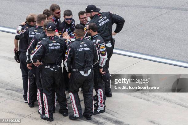 Crew members of Kasey Kahne , driver of the Liftmaster Chevrolet, huddle together prior to the start of the Monster Energy NASCAR Cup Series - Pure...