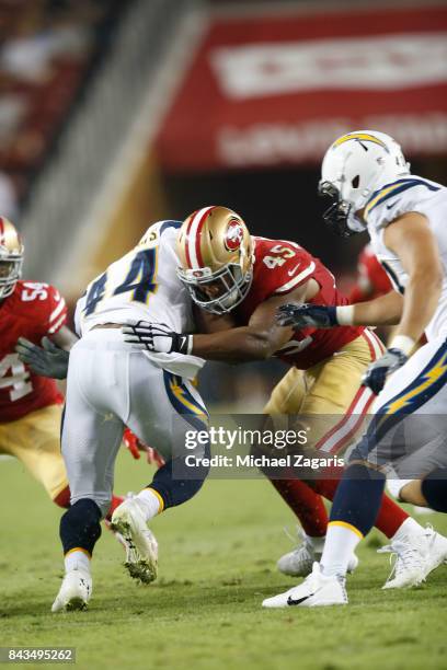 Pita Taumoepenu of the San Francisco 49ers tackles Andre Williams of the Los Angeles Chargers during the game at Levi's Stadium on August 31, 2017 in...