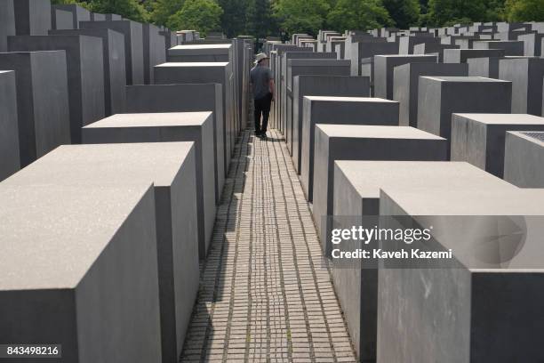 Man walks amid the concrete slabs or "stelae" in The Memorial to the Murdered Jews of Europe, also known as the Holocaust Memorial designed by...