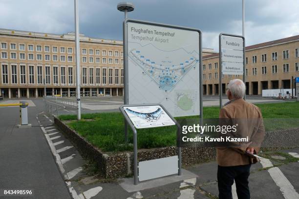 Outside the main building a man looks at the map of Tempelhof Airport which was used by the Nazis massively during World War II and commonly known as...