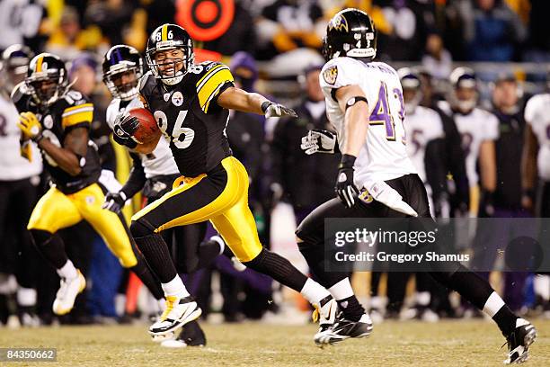 Wide receiver Hines Ward#86 of the Pittsburgh Steelers runs the ball against Haruki Nakamura of the Baltimore Ravens during the AFC championship game...