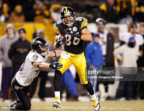 Wide receiver Hines Ward#86 of the Pittsburgh Steelers runs the ball against Haruki Nakamura of the Baltimore Ravens during the AFC championship game...