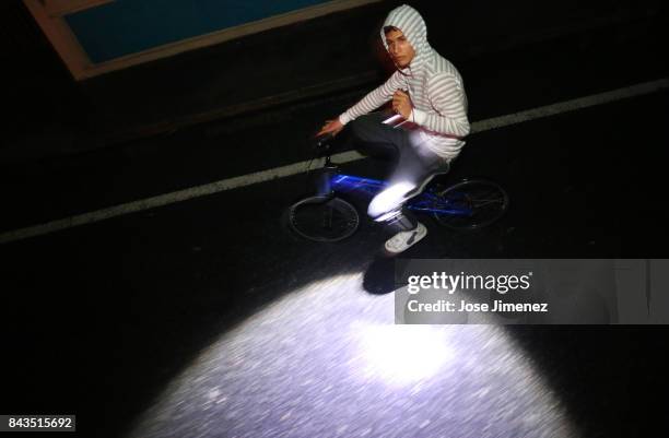 Local resident rides his bike after the passing of Hurricane Irma on September 6, 2017 in Fajardo, Puerto Rico. The category 5 storm is expected to...