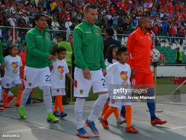 Arturo Vidal of Chile and Pablo Escobar of Bilivia enter the field prior to a match between Bolivia and Chile as part of FIFA 2018 World Cup...