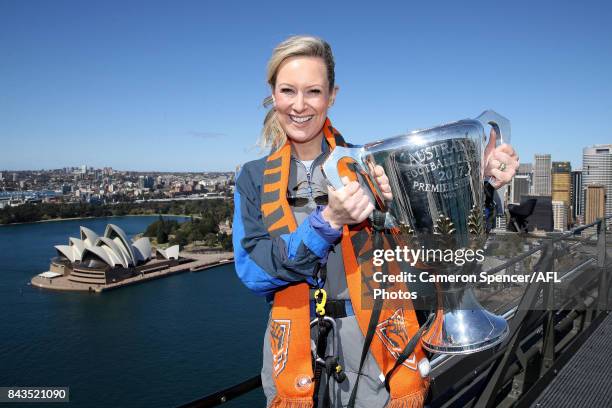 Giants fan Melissa Doyle poses with the AFL Premiership Cup on top of the Sydney Harbour Bridge on September 7, 2017 in Sydney, Australia.