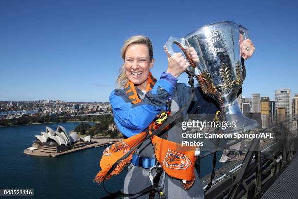 Giants fan Melissa Doyle poses with the AFL Premiership Cup on top of the Sydney Harbour Bridge on September 7, 2017 in Sydney, Australia.