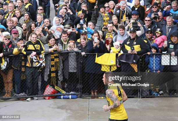 Dustin Martin of the Tigers runs out in front of fans during a Richmond Tigers AFL training session at Punt Road Oval on September 7, 2017 in...
