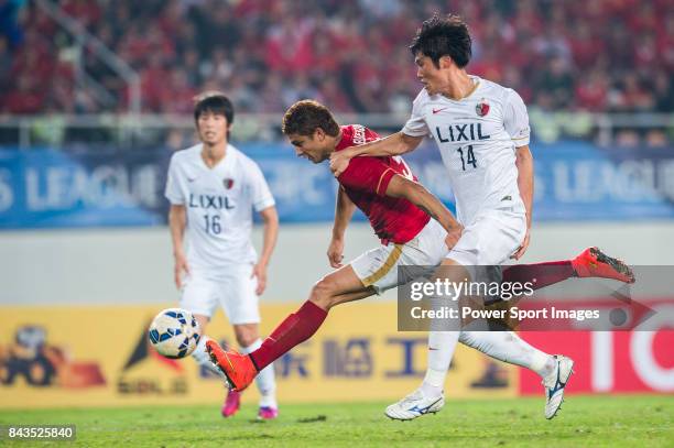 Guangzhou Evergrande forward Elkeson De Oliveira Cardoso fights for the ball with Kashima Antlers defender Hwang Seokho during the AFC Champions...