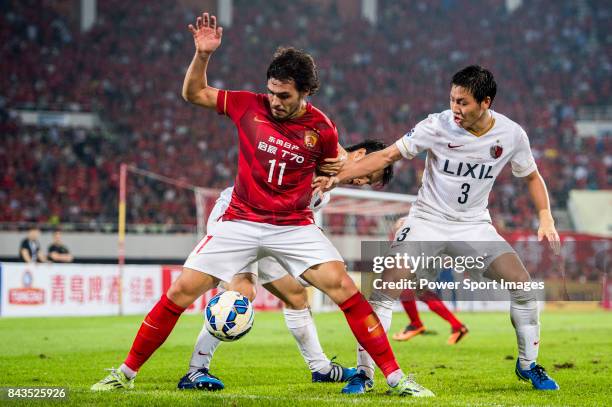 Guangzhou Evergrande midfielder Goulart Pereira fights for the ball with Kashima Antlers defender Shoji Gen during the AFC Champions League 2015...