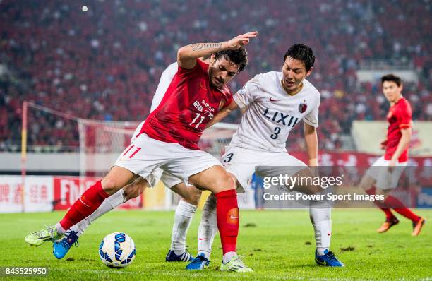 Guangzhou Evergrande midfielder Goulart Pereira fights for the ball with Kashima Antlers defender Shoji Gen during the AFC Champions League 2015...