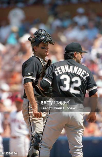 Carlton Fisk of the Chicago White Sox confers with Alex Fernandez in a game against the California angels at the Big A circa 1992 in...