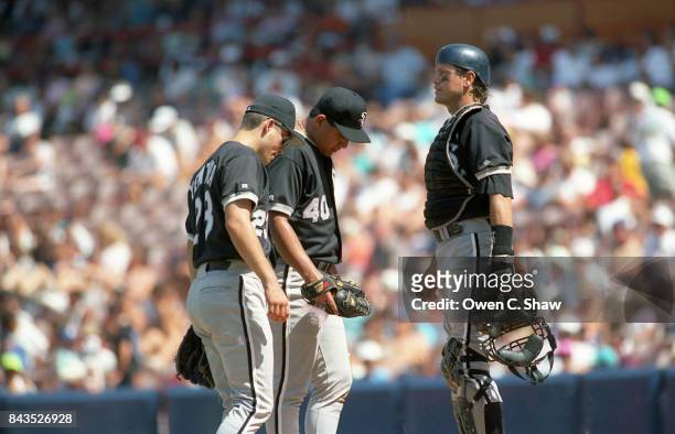 Carlton Fisk of the Chicago White Sox confers with his pitcher Wilson Alvarez in a game against the California Angels at the Big A circa 1992 in...