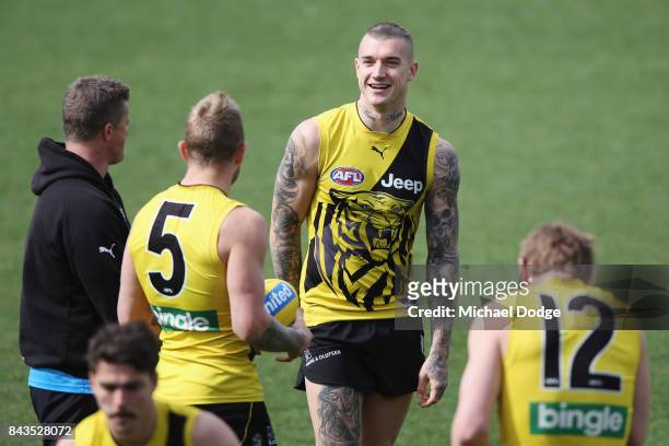 Dustin Martin of the Tigers reacts with Tigers head coach Damien Hardwick during a Richmond Tigers AFL training session at Punt Road Oval on...