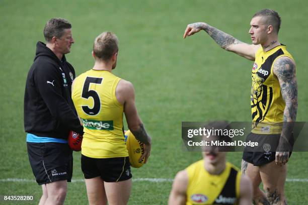 Dustin Martin of the Tigers reacts with Tigers head coach Damien Hardwick during a Richmond Tigers AFL training session at Punt Road Oval on...