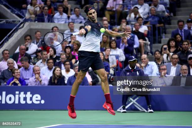 Roger Federer of Switzerland returns a shot against Juan Martin del Potro of Argentina during their Men's Singles Quarterfinal match on Day Ten of...