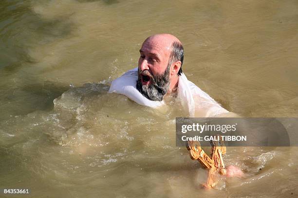 Christian Orthodox pilgrim immerses himself in the water of the Jordan River during the Epiphany celebrations in Kasser-el-Yahud on January 18, 2009....