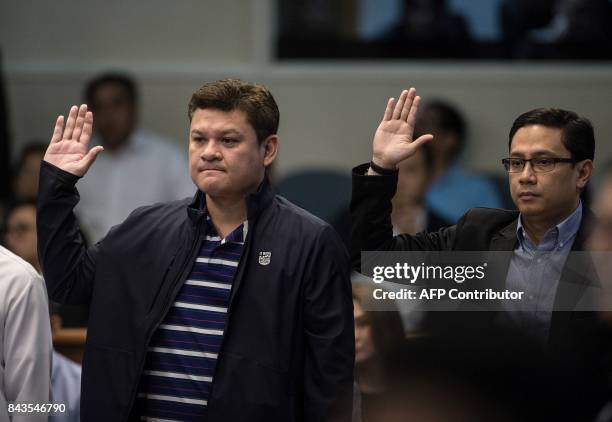 Davao City Vice Mayor Paolo Duterte , son of Philippine President Rodrigo Duterte, and the president's son-in-law, Manases Carpio , take an oath as...