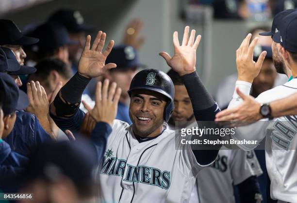 Nelson Cruz of the Seattle Mariners is congratulated by teammates after scoring on a hit by Mitch Haniger of the Seattle Mariners off of relief...