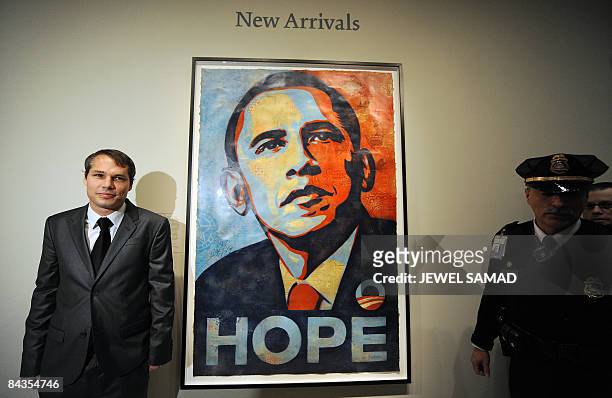 Artist Shepard Fairey poses next to his portrait of US President-elect Barack Obama at the National Portrait Gallery in Washington on January 17,...