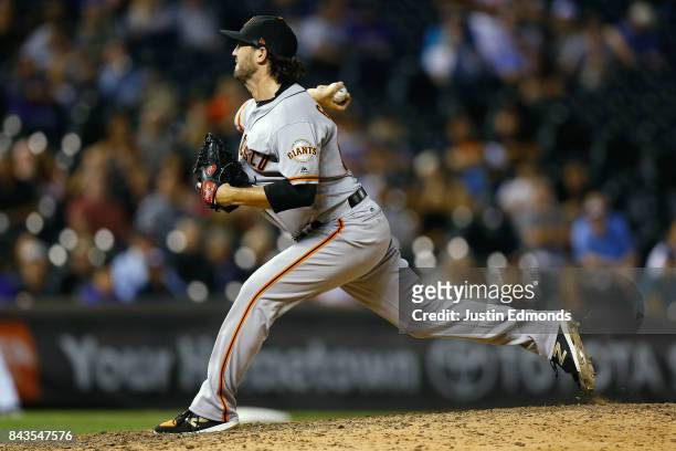 Relief pitcher Cory Gearrin of the San Francisco Giants delivers to home plate during the eighth inning against the Colorado Rockies at Coors Field...