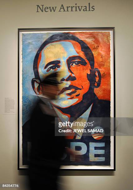 Policeman walks past Shepard Fairey's portrait of US President-elect Barack Obama after it was installed at the National Portrait Gallery in...
