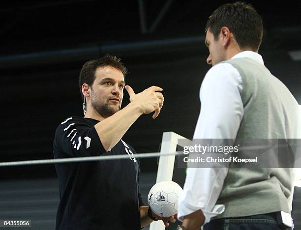 Television channel moderator Marcus Schreyl and Handball expert Markus Baur talk each othe during the Men's World Handball Championships match...