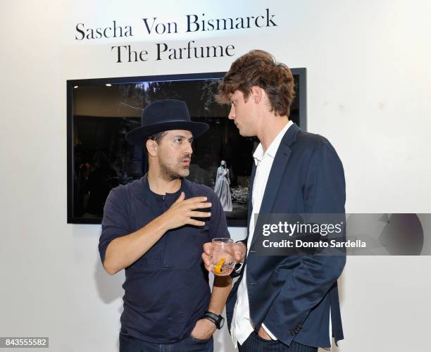 Sami Hayek, Photographer Sascha von Bismarck and celebrity floral and fragrance designer Eric Buterbaugh attend the private opening of Sascha von...