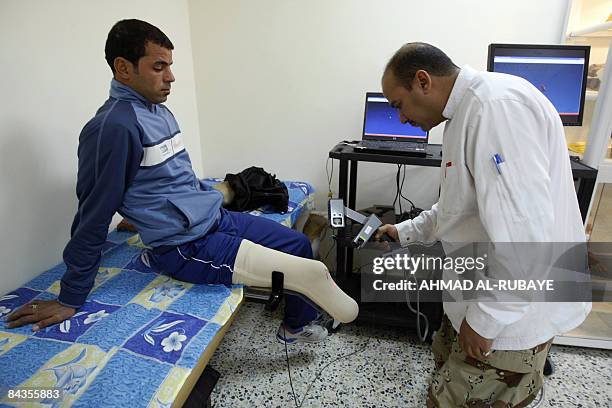 Iraqi soldier Ali Khalid , who lost part of his leg in an improvised explosive device bombing in mid-2007, is examined by a doctor during at the...