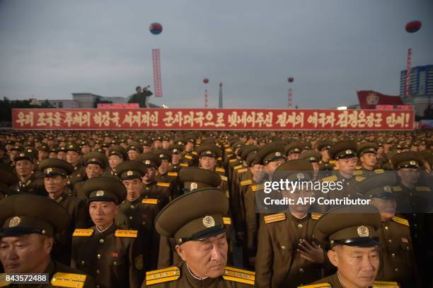 In a photo taken on September 6 Korean People's Army soldiers attend a mass celebration in Pyongyang for scientists involved in carrying out North...