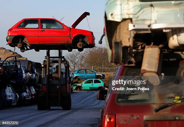 Wreckages of cars are piled up at a scrap yard on January 19, 2009 in Hamburg, Germany. Germany unveiled a new 50 billion euro stimulus package on...