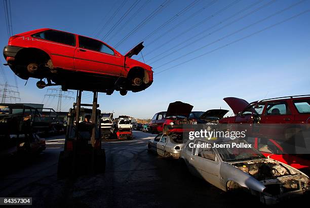 Wreckages of cars are piled up at a scrap yard on January 19, 2009 in Hamburg, Germany. Germany unveiled a new 50 billion euro stimulus package on...