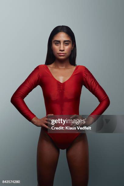 cool female gymnast looking in camera, wearing leotard - gympak stockfoto's en -beelden