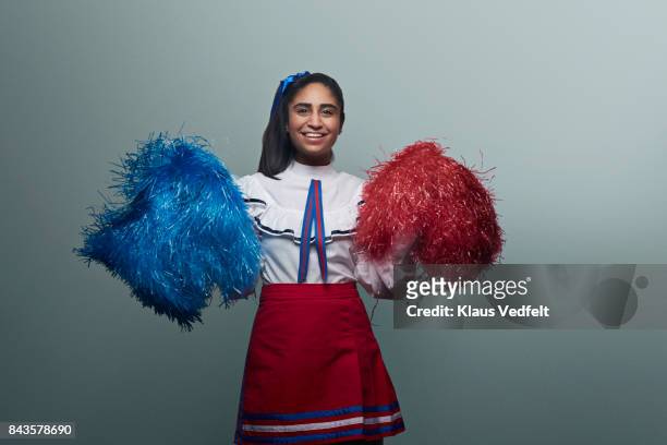 female cheerleader with pom poms, laughing to camera - bolo stock pictures, royalty-free photos & images