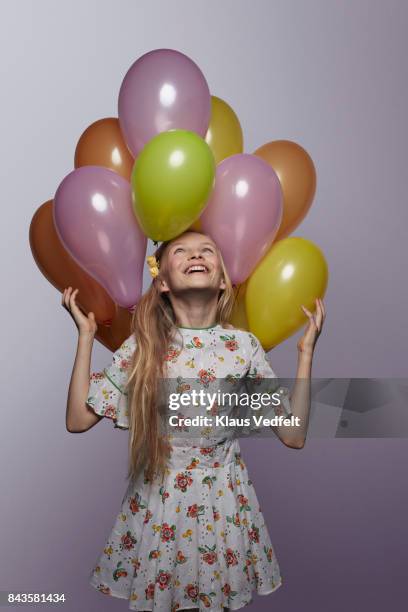 cute girl looking up at stack of balloons - 11-13 2017 stock pictures, royalty-free photos & images