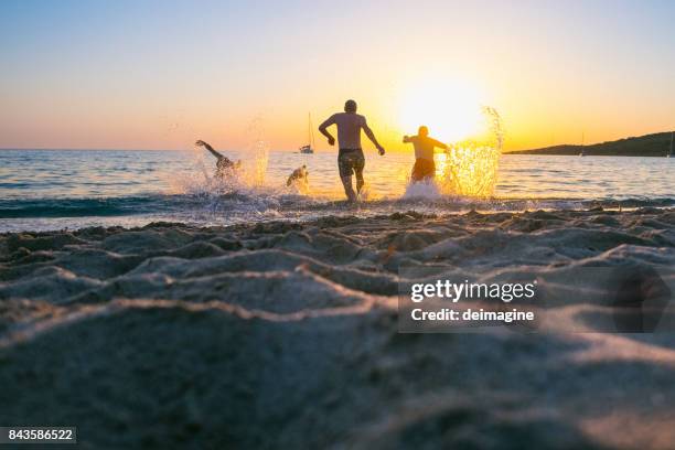 young men running into the sea - nice france stock pictures, royalty-free photos & images