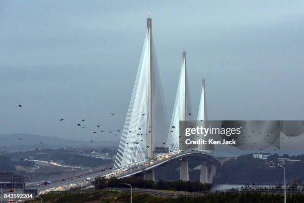 Flock of crows flies in front of the new Queensferry Crossing road bridge over the Forth Estuary as it opens permanently to traffic, on September 7,...