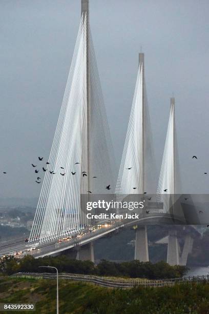 Flock of crows flies in front of the new Queensferry Crossing road bridge over the Forth Estuary as it opens permanently to traffic, on September 7,...