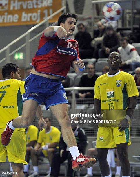 Serbia's Nenad Vuckovic shoots through Brazil's defence during their Men's World Handball Championship preliminary Group D match in Porec on 19...